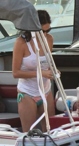 Bikini babe on a boat with a wet see through white shirt showing her tits