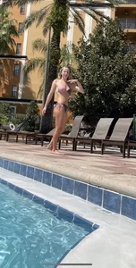 Girl doing a handstand by the pool