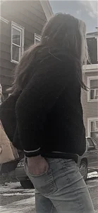 Teen wearing jeans with her hands in back pockets