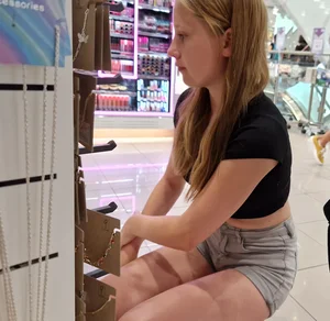 A Cute Young Candid Girl in Shorts And a Top at the Store