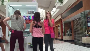 Little blonde teen in grey leggings at the mall with her friends