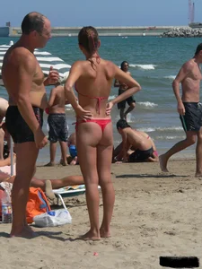 A bunch of hot babes on the beach in thong bikinis