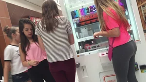 Little blonde teen in grey leggings at the mall with her friends