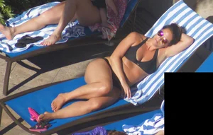 Milf laying out in black bikini by the pool