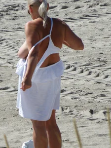 Mature blonde lady on a nude beach with big boobs