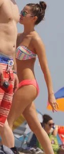 Two sexy girls in peach and pink bikinis on the beach