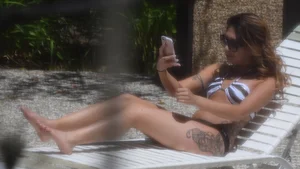 Sexy Asian girl with tattoos in a thong bikini