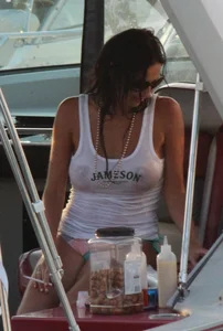 Bikini babe on a boat with a wet see through white shirt showing her tits