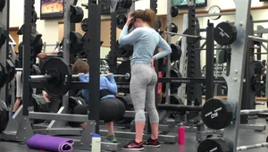 Two sexy girls working out at the gym in glasses and leggings with amazing asses