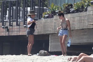 Ashley Tisdale in cheetah print swimsuit on the beach in Malibu