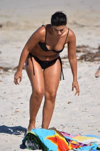 Thick mature brunette bikini lady on the beach with a nice body