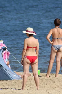 Couple of hot babes hanging out at the beach in bikinis