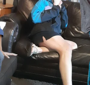 Blonde date with great legs in black miniskirt dressed as delivery girl at Halloween party