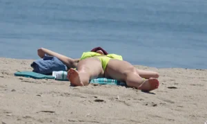 Sexy ass blonde milf on the beach in a thong with cameltoe and bending over