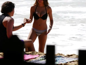 Sexy ass brunette with a perfect body in bikini on the beach