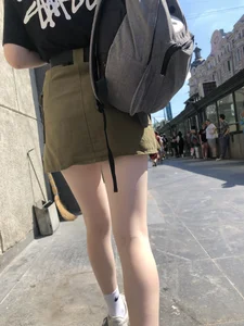 Cute Candid Teen Girl in a Skirt With a Backpack Passing By on the Street - Very Pale Legs With Smooth Skin