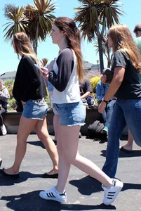 Cute girl walking in short jean shorts