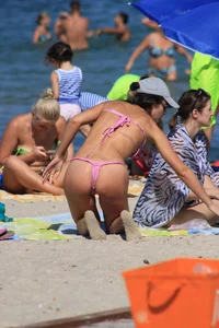 Sexy milf in pink thong bikini on the beach