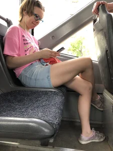 Girl in Jeans Shorts Sitting Cross-Legged in the Bus Candid