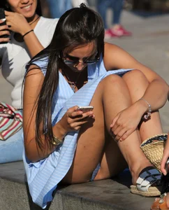 Girl in a Blue Dress and Sunglasses Flashing Panties While Sitting With Bent Legs - Lip Slip Street Candid Photo