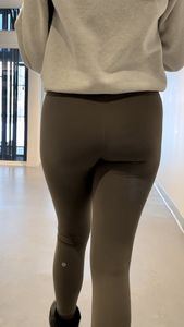 Following the blonde with Fake lashes in green leggings