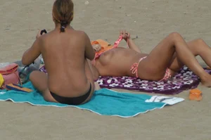 Topless girls on a beach in Barcelona