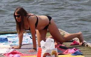 Thick babe with big boobs in a black bikini