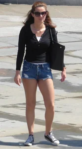 Cute girl with nice legs in short denim shorts