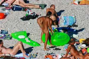 FKK Nudists playing in the water with floater
