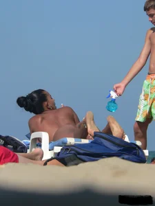 Hot ass topless beach girl with great tits lets her little brother oil up her ass in thong bikini