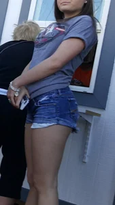 Brunette teen jean shorts in line