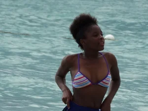 Candid black family, milf and teens on the beach in bikinis