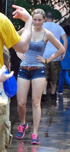 Cute blonde in denim shorts and a wet top