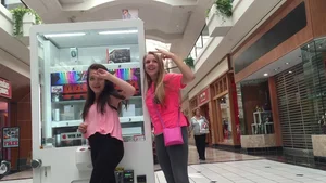Little blonde teen in grey leggings at the mall with her friends