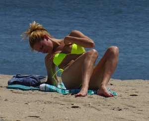 Sexy ass blonde milf on the beach in a thong with cameltoe and bending over