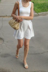 Sexy lady in a dress and high heeled sandals with slim legs suburban street creepshots