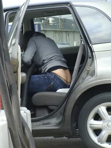 Girl cleaning her car in jeans and showing some cheetah print underwear