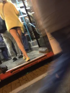 Hot Blonde with Long Skinny Legs Behind the Closing Doors of the Tram