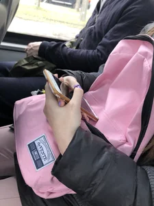 Cute teen girl's manicured hands holding a phone in a public bus creepshots