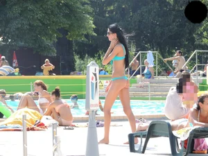 Tall and skinny brunette babe at the pool in a teal thong bikini