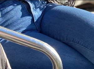 Closeup of a Milf's Crotch Sitting With Crossed Legs in Blue Jeans