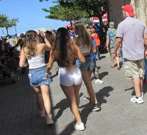 Three sexy friends in denim shorts and a skirt