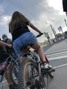 Girl in denim shorts on a bike street pics