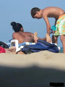 Hot ass topless beach girl with great tits lets her little brother oil up her ass in thong bikini