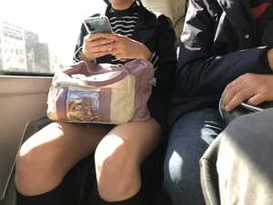 A Very Cute And Skinny Candid Teen Girl Wearing Glasses, A Skirt And Knee Socks Sitting in a Public Bus, Closeups of Her Legs