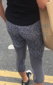 Sexy girl walking in grey patterned leggings with friend in tight jeans
