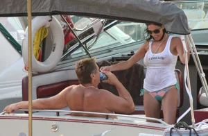 Bikini babe on a boat with a wet see through white shirt showing her tits