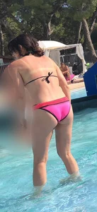 Sexy girl at the pool in pink bikini