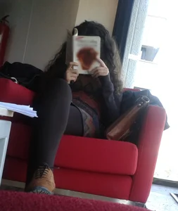 Candid Girl in Leggings Reading a Book With Crossed Legs at the Library Creepshot
