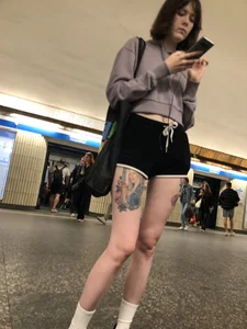A Tall And Slim Candid Girl in Spandex Shorts in a Hoodie Top, With Tattoos on Her Long Legs Subway Creepshots